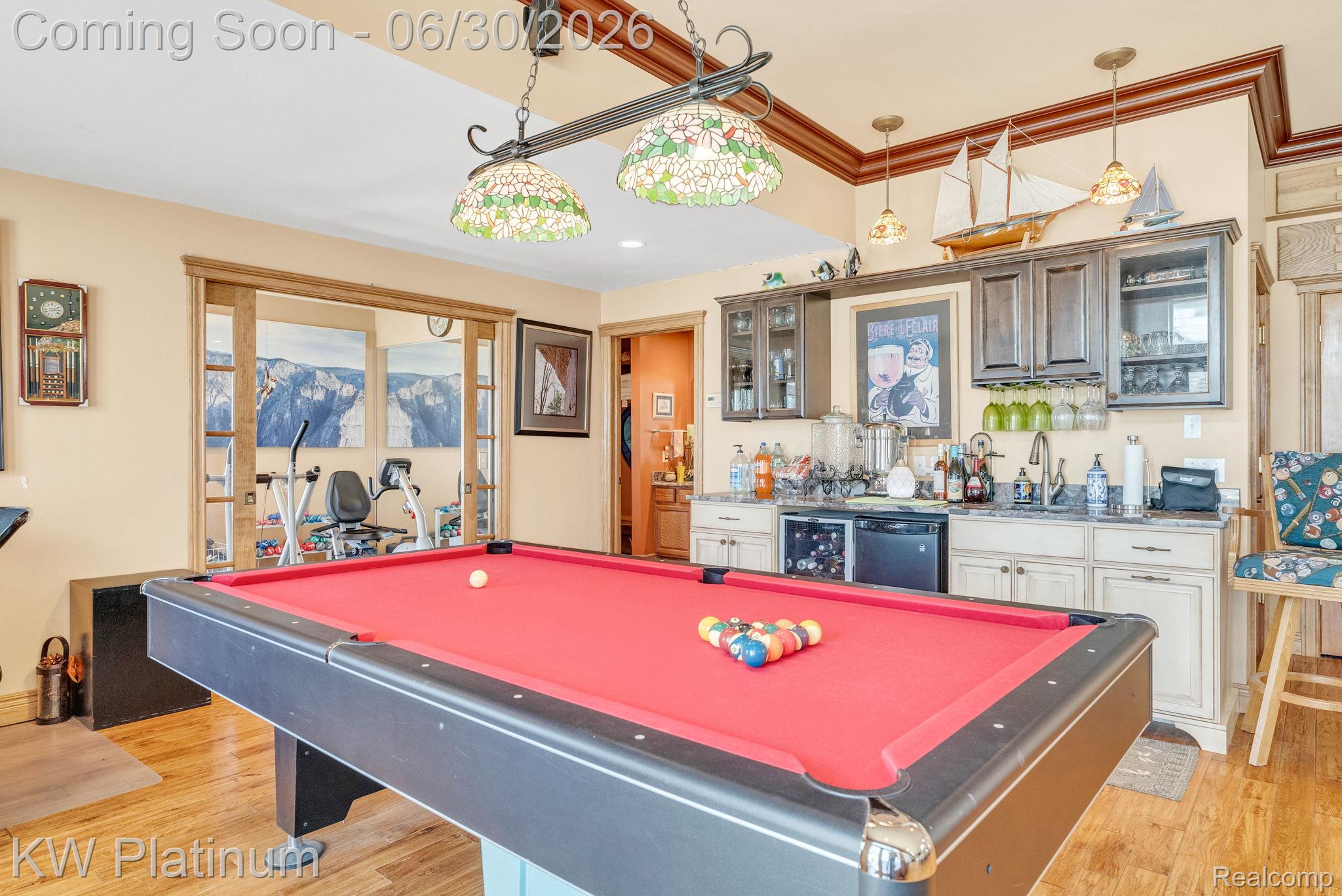 2235 South Lake Shore Road Harbor Beach, MI 48441 - Photo 20 of 99 Entertainment space featuring a large pool table, hardwood-finish flooring, and a built-in wet bar with a beverage refrigerator