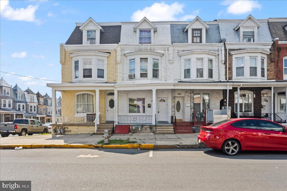 1302 North 11th Street Reading, PA 19604 - Photo 1 of 16 a front view of a building with lots of cars and trees