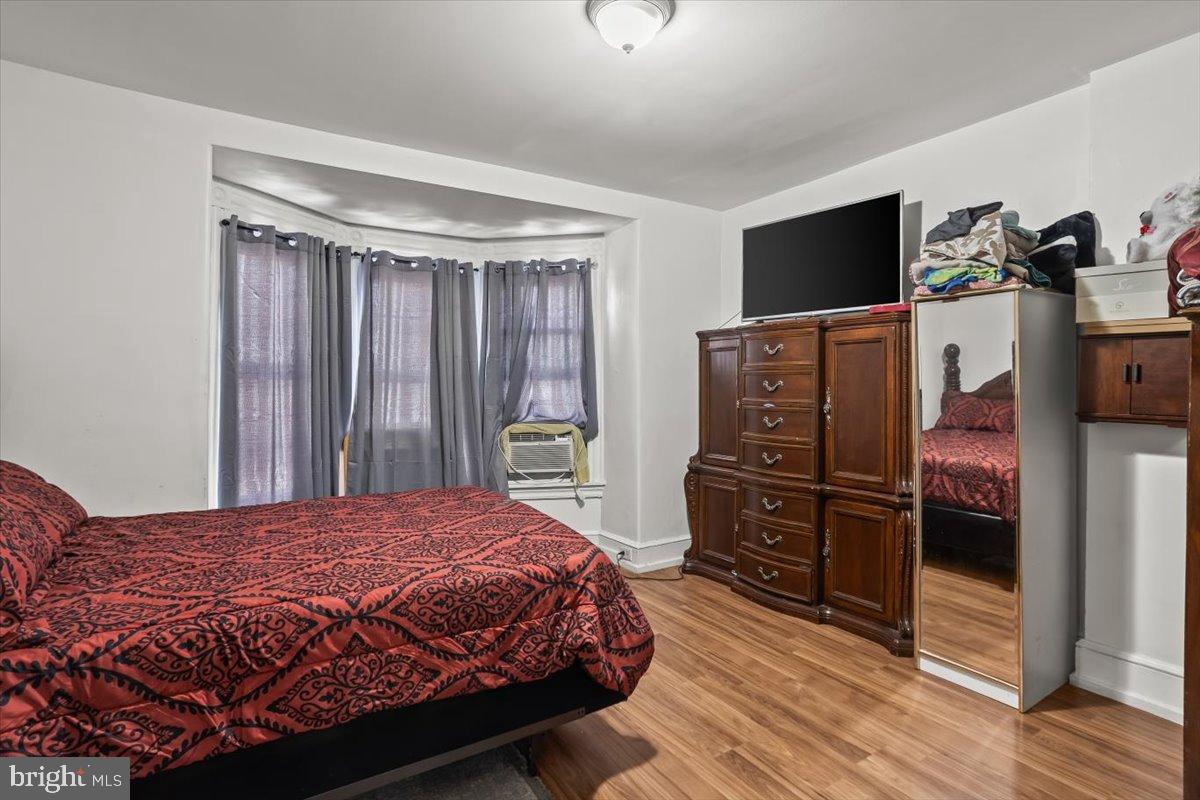 1302 North 11th Street Reading, PA 19604 - Photo 11 of 16 a bedroom with a bed and wooden floor