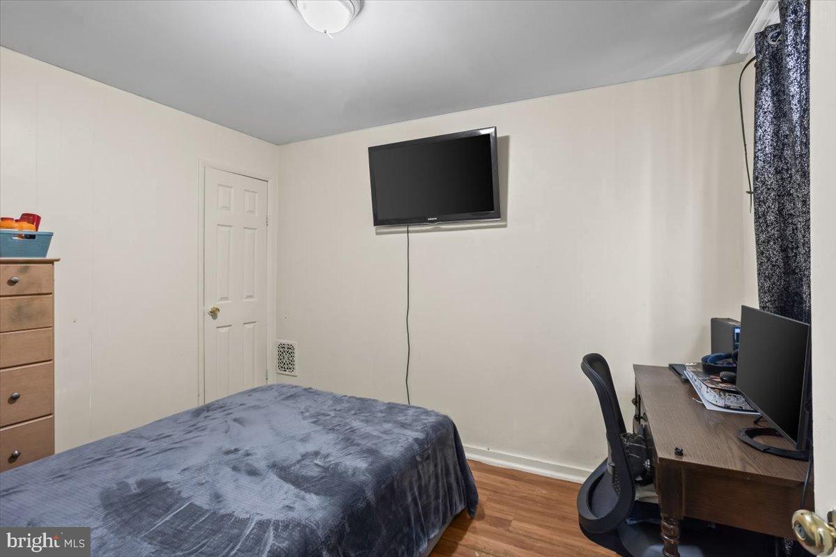 1302 North 11th Street Reading, PA 19604 - Photo 13 of 16 a bedroom with a bed and a flat screen tv