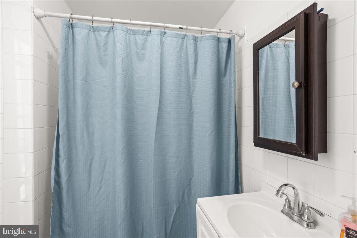 1302 North 11th Street Reading, PA 19604 - Photo 15 of 16 a bathroom with a sink and a mirror