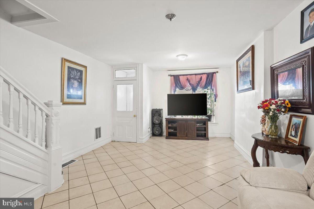 1302 North 11th Street Reading, PA 19604 - Photo 3 of 16 a living room with furniture and a flat screen tv