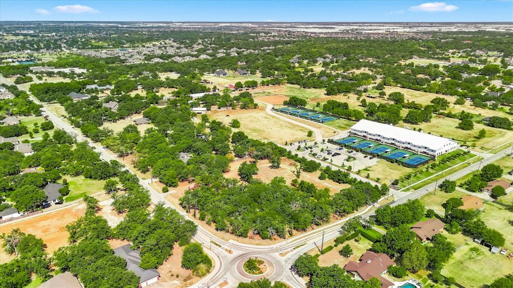 1347 Johnson Road Keller, TX 76248 - Photo 9 of 18 Expansive property featuring abundant mature trees, paved roads, and a clear blue sky