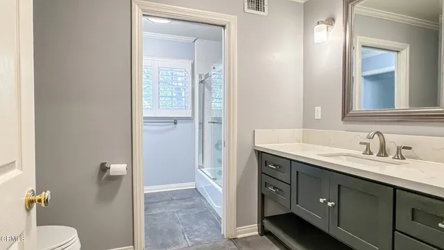 a spacious bathroom with a granite countertop sink toilet and shower