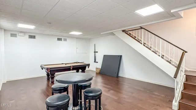 a view of a hallway with chairs and a potted plant
