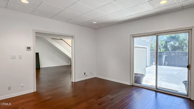 an empty room with wooden floor and door