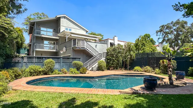 an aerial view of residential houses with outdoor space and street view