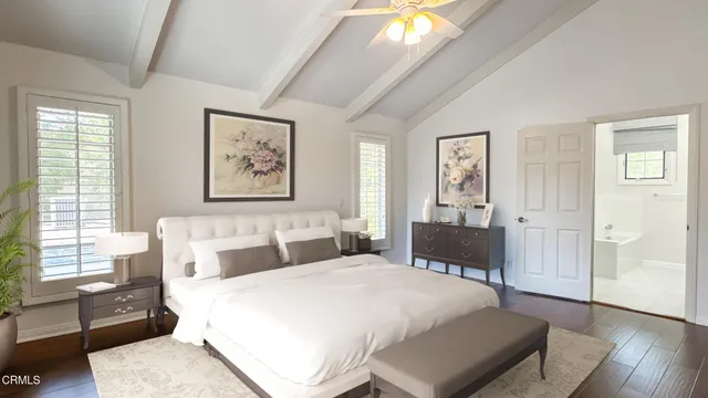 a spacious bedroom with a bed and wooden floor