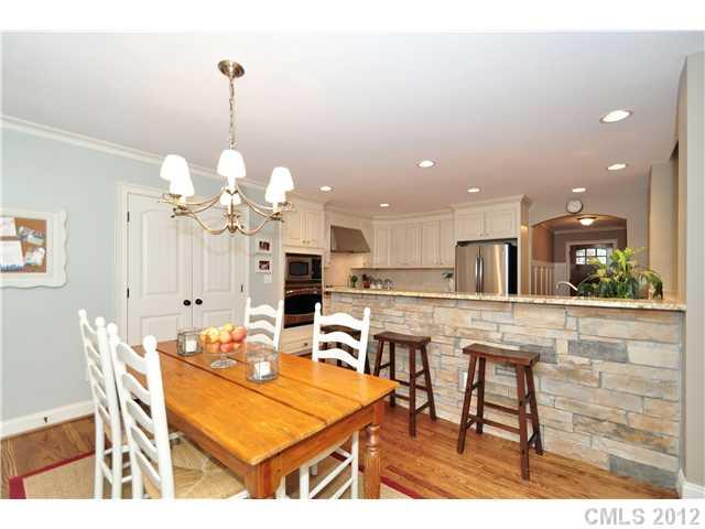 142 McAlway Road Charlotte, NC 28211 - Photo 7 of 16 a dining room filled chandelier and kitchen view
