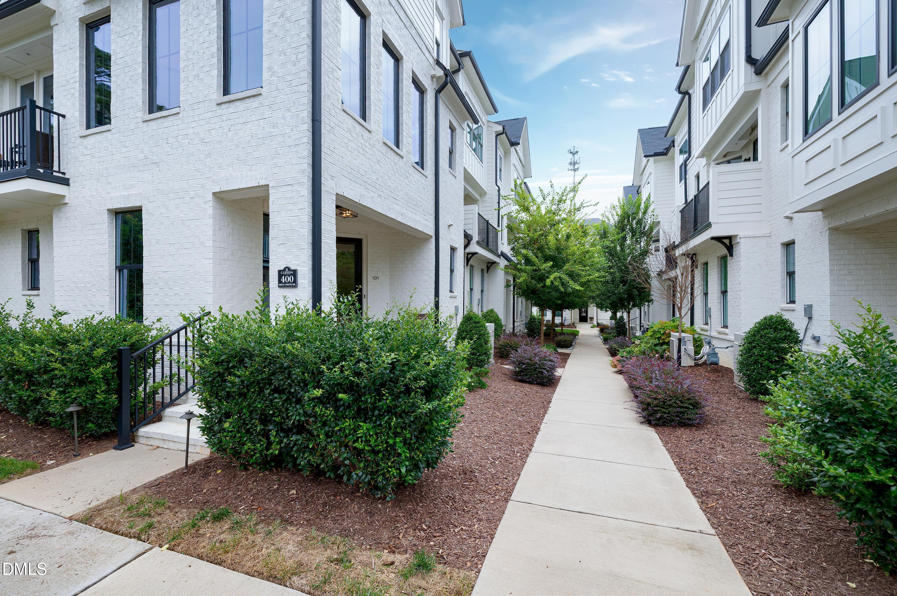 400 Bryan Pointe Drive, Unit 104 Raleigh, NC 27608 - Photo 8 of 66 a view of a pathway both side of the house