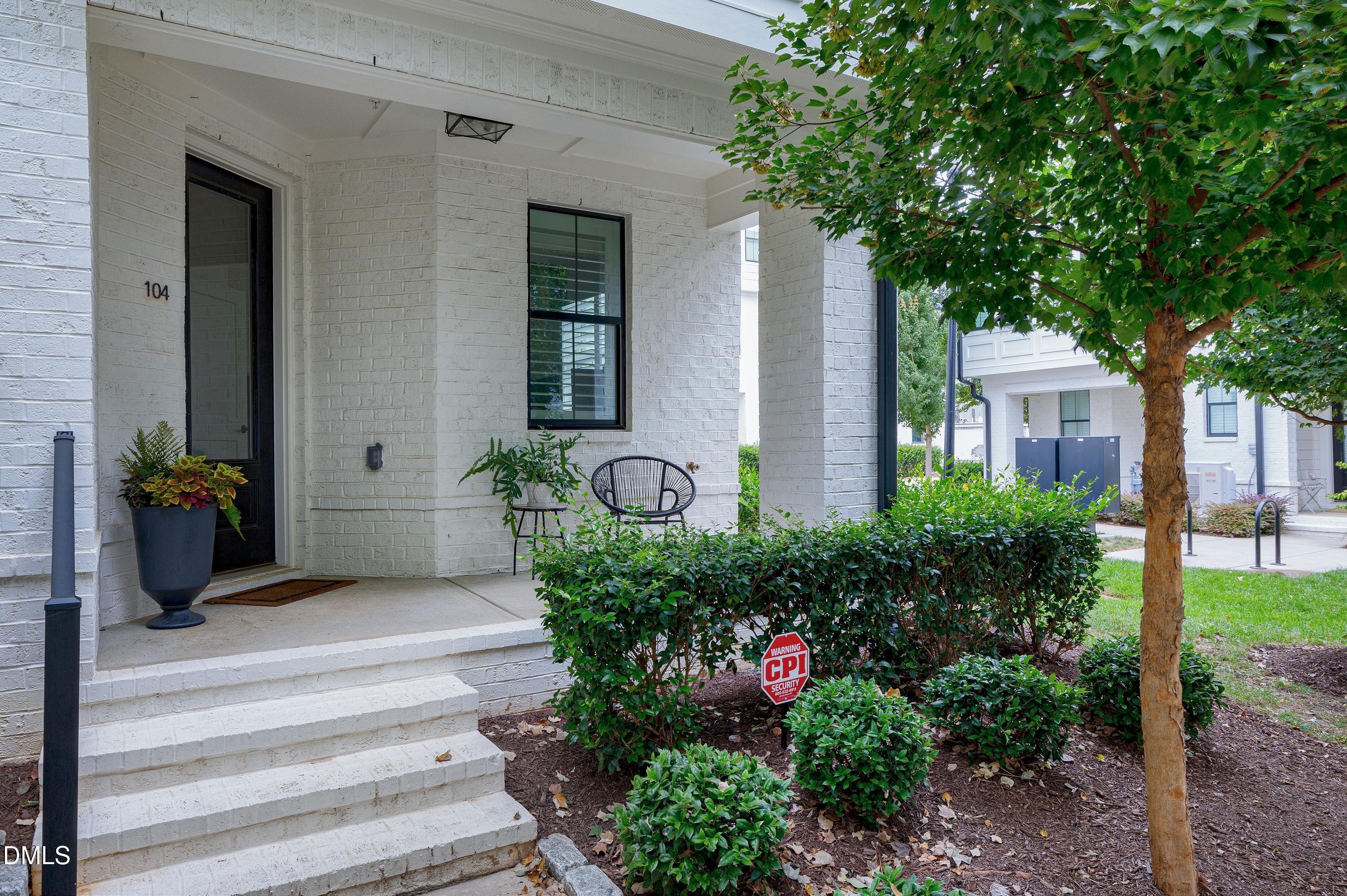 400 Bryan Pointe Drive, Unit 104 Raleigh, NC 27608 - Photo 10 of 66 a front view of a house with a garden