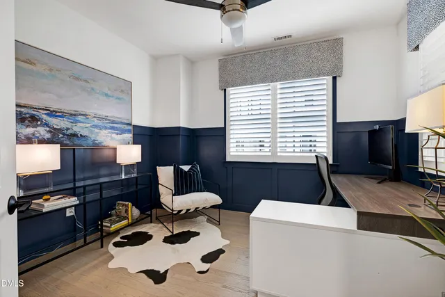 a living room with furniture and a lamp