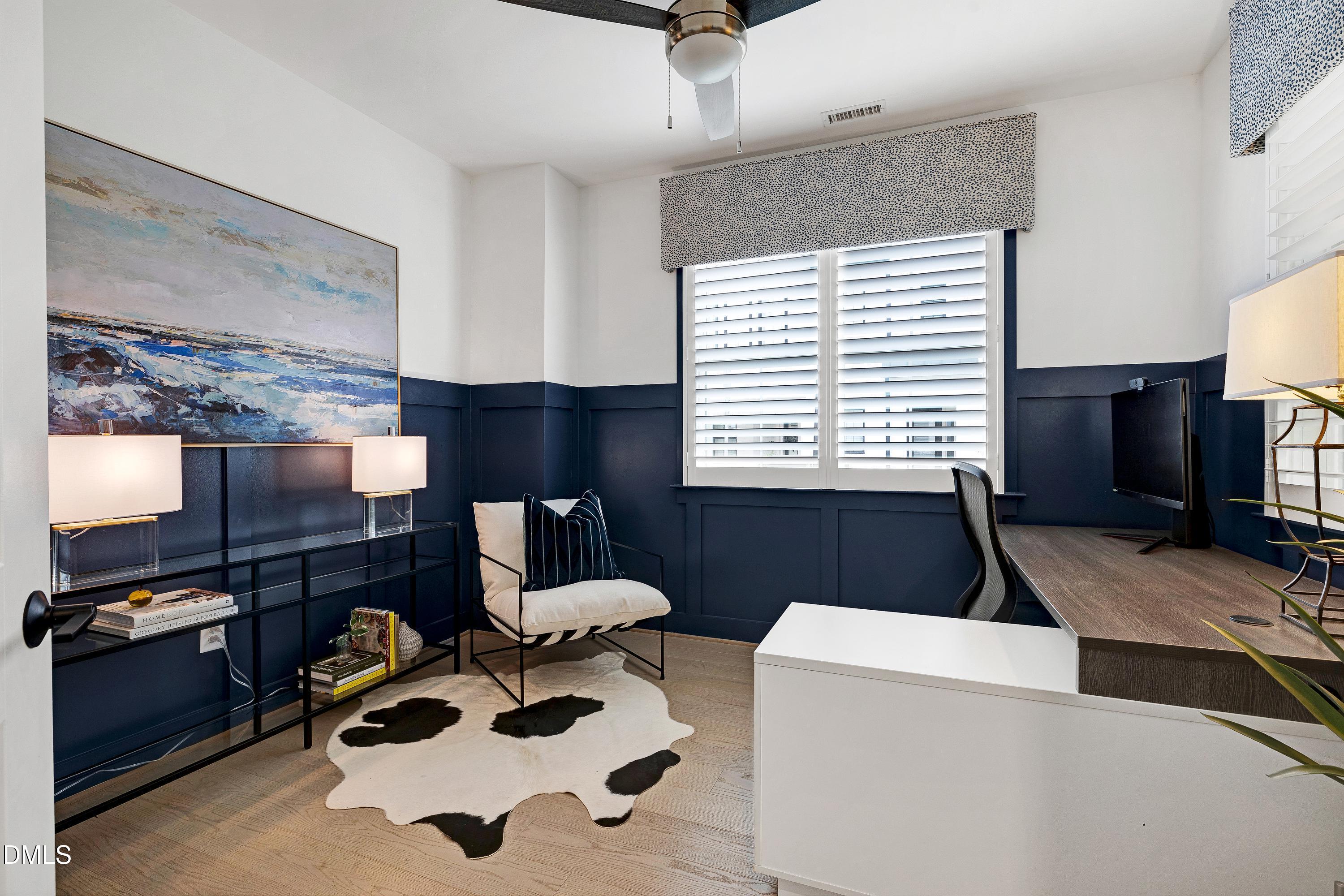 400 Bryan Pointe Drive, Unit 104 Raleigh, NC 27608 - Photo 12 of 66 a living room with a couch a fireplace and a flat screen tv