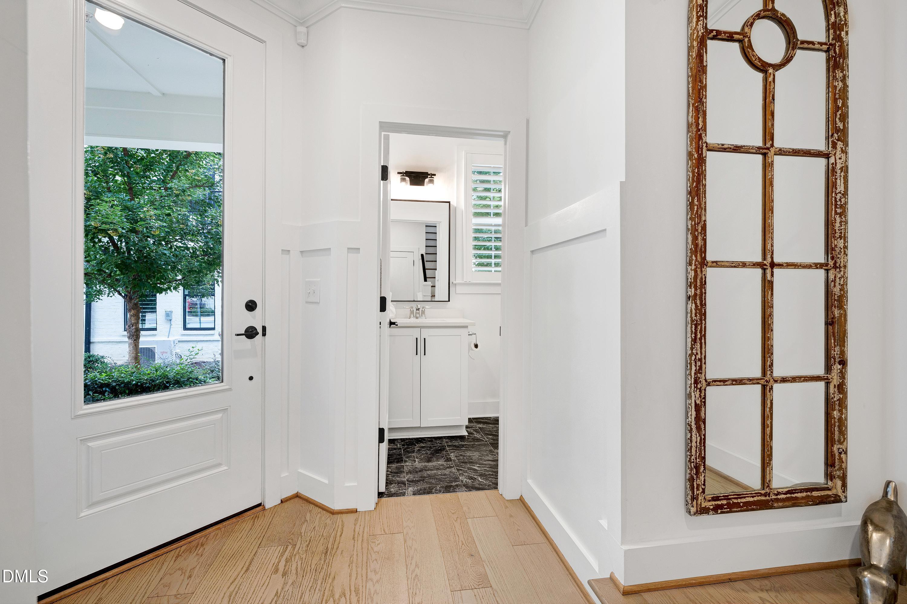 400 Bryan Pointe Drive, Unit 104 Raleigh, NC 27608 - Photo 15 of 66 a view of a room with wooden floor and windows