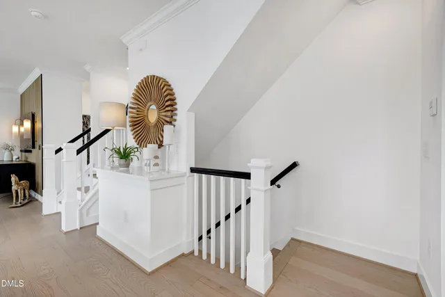 a kitchen with white cabinets and sink