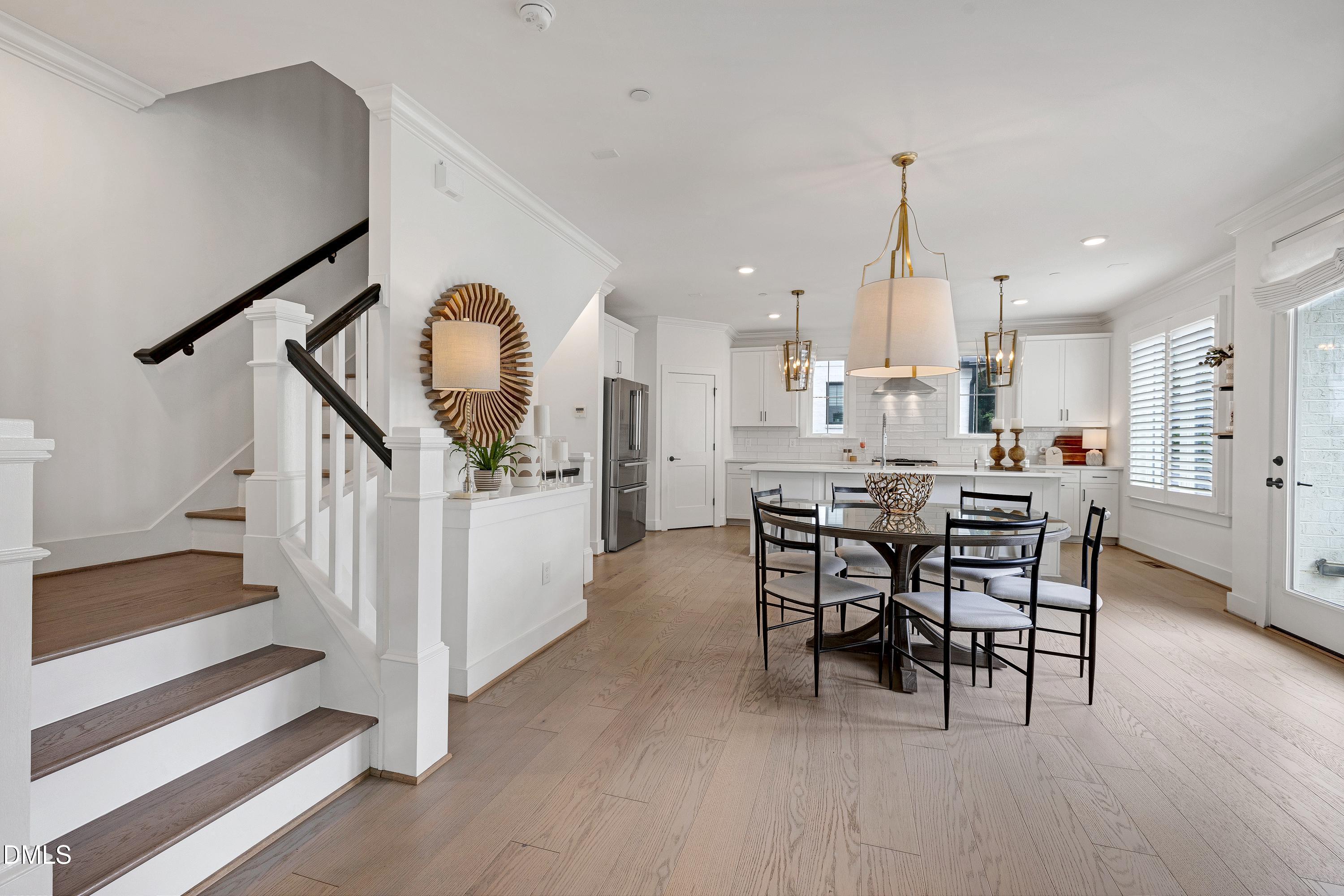 400 Bryan Pointe Drive, Unit 104 Raleigh, NC 27608 - Photo 21 of 66 a view of a dining room with furniture and wooden floor