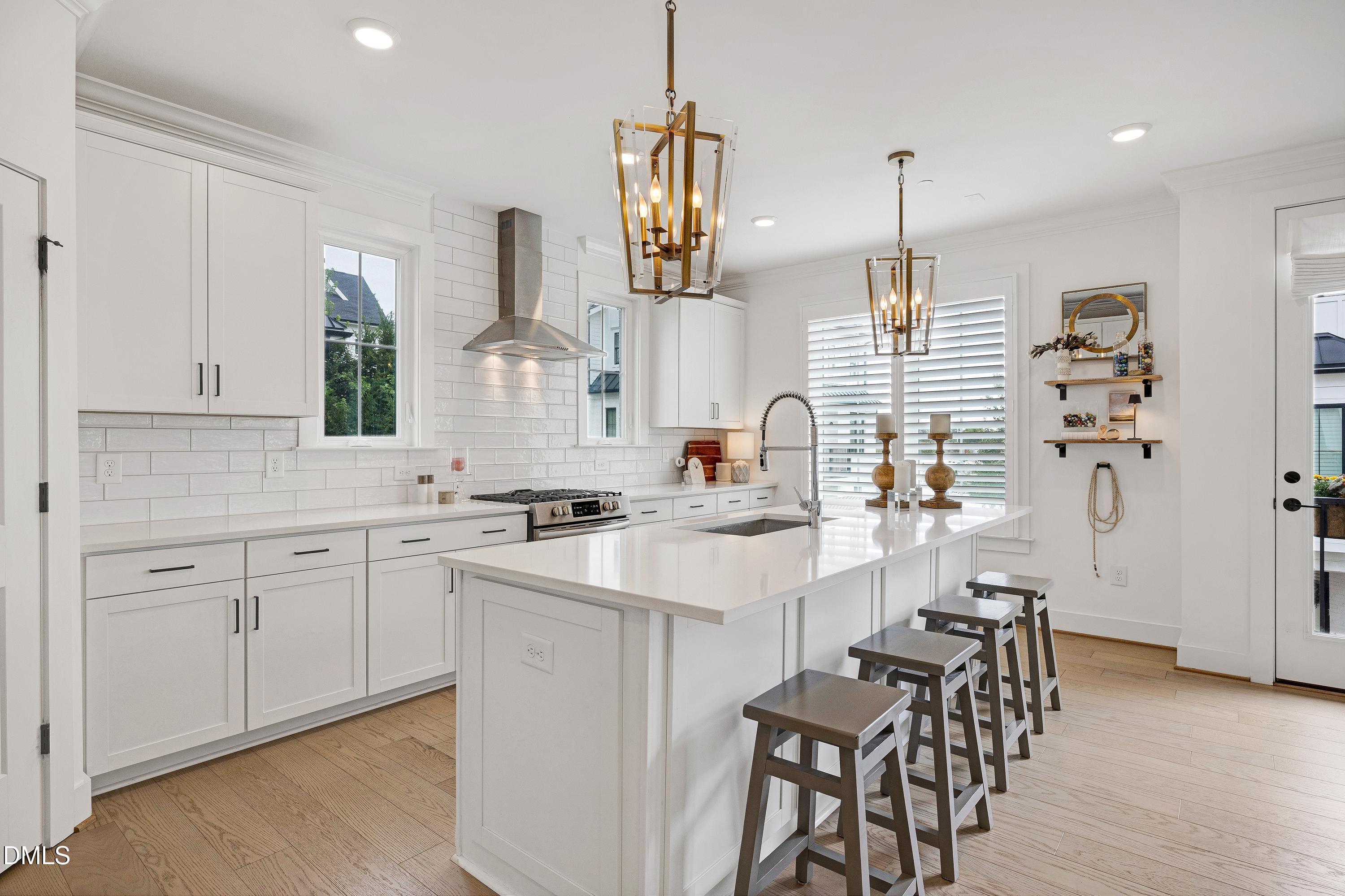 400 Bryan Pointe Drive, Unit 104 Raleigh, NC 27608 - Photo 22 of 66 a kitchen with white cabinets and sink