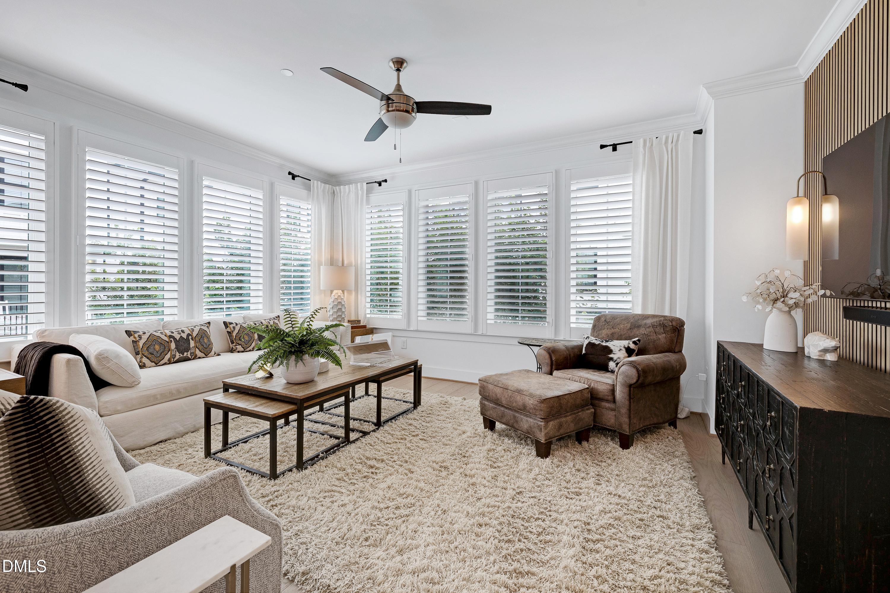 400 Bryan Pointe Drive, Unit 104 Raleigh, NC 27608 - Photo 25 of 66 a living room with furniture and large windows