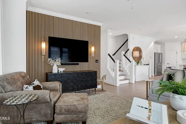 a living room with furniture a wooden floor and a chandelier