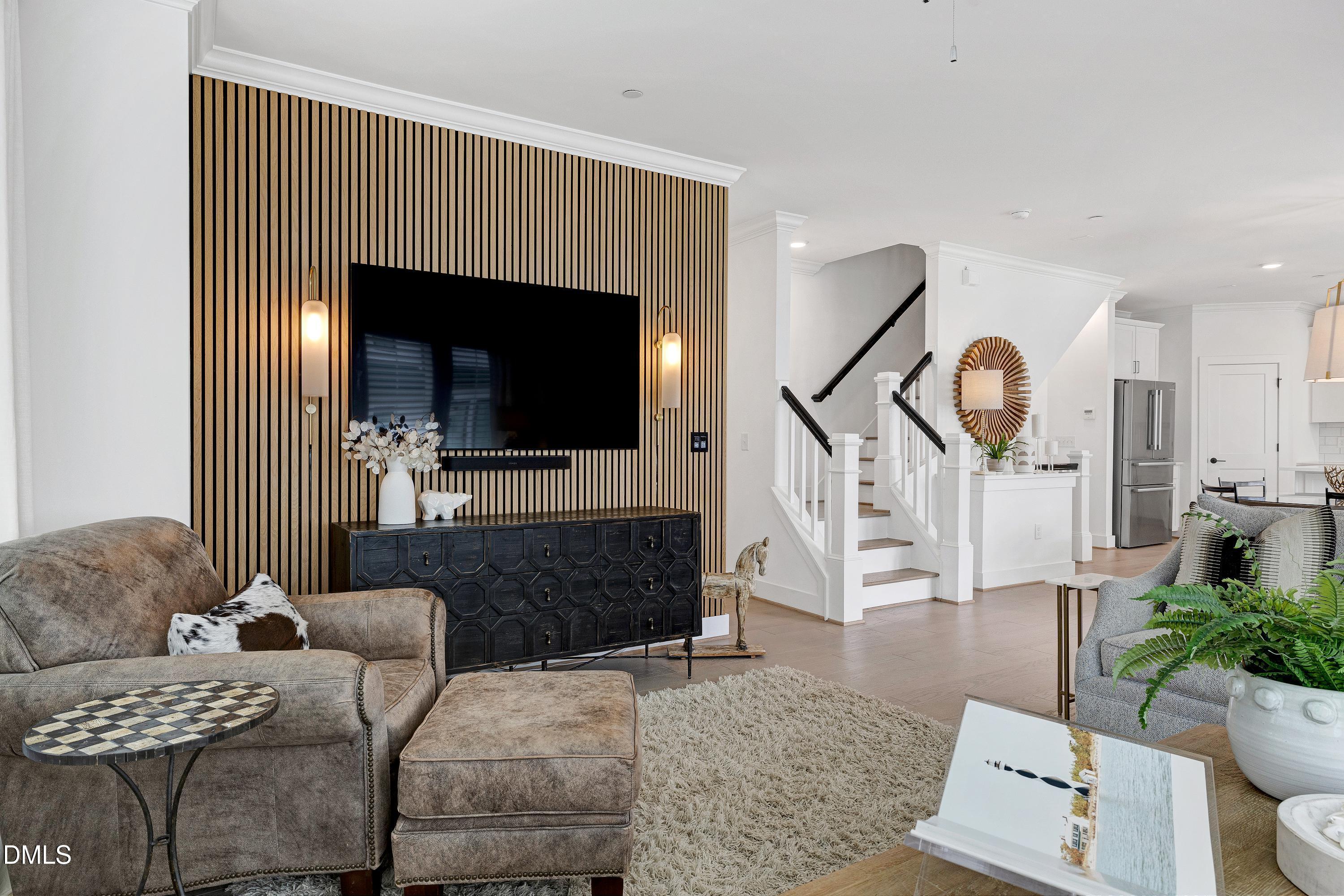 400 Bryan Pointe Drive, Unit 104 Raleigh, NC 27608 - Photo 26 of 66 a living room with furniture and a flat screen tv