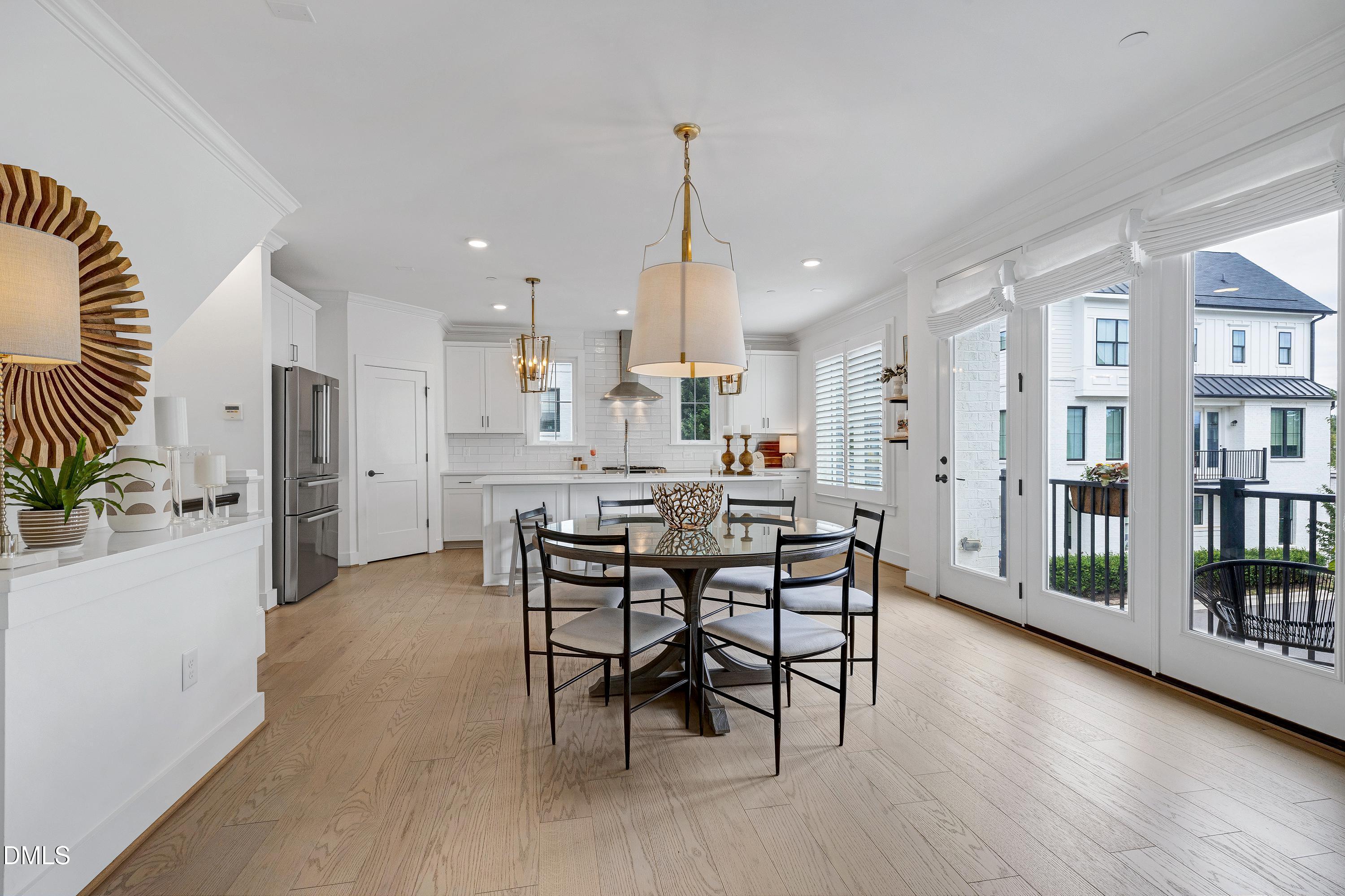 400 Bryan Pointe Drive, Unit 104 Raleigh, NC 27608 - Photo 27 of 66 a view of a dining room with furniture and floor to ceiling window