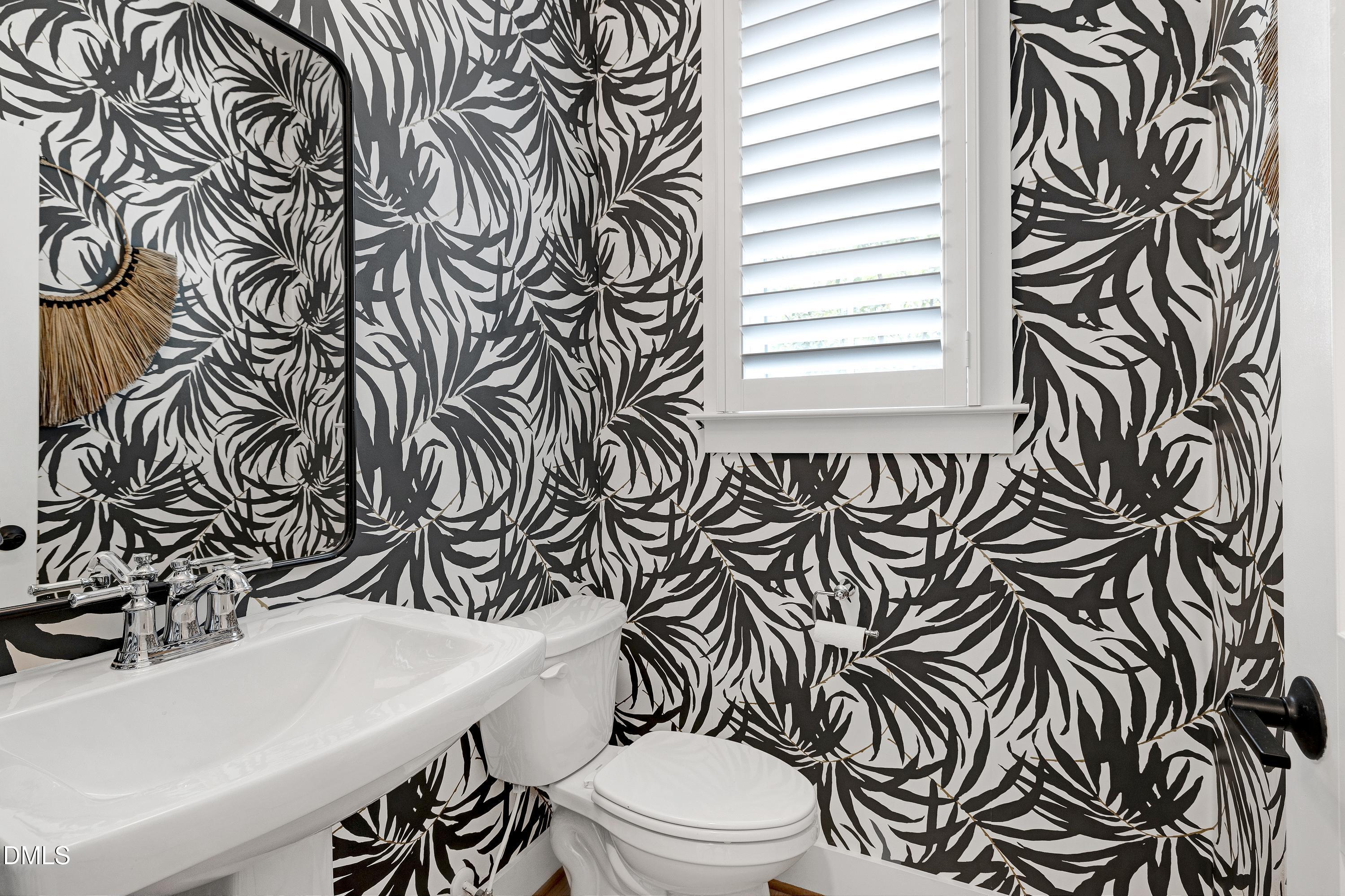 400 Bryan Pointe Drive, Unit 104 Raleigh, NC 27608 - Photo 28 of 66 a bathroom with a sink a toilet and a window
