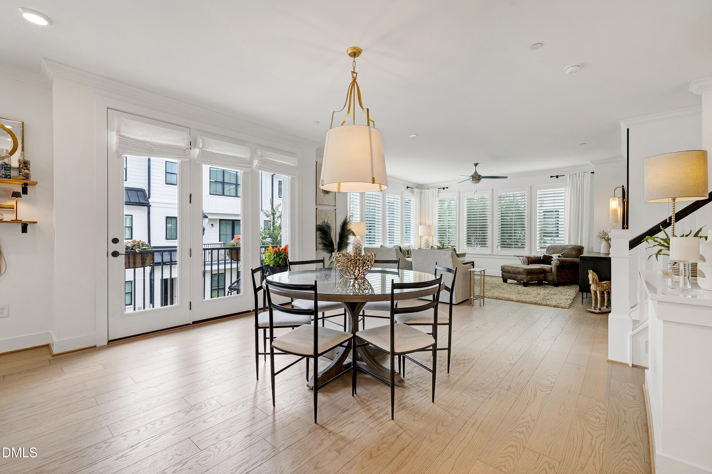 400 Bryan Pointe Drive, Unit 104 Raleigh, NC 27608 - Photo 29 of 66 a living room with furniture a wooden floor and a chandelier