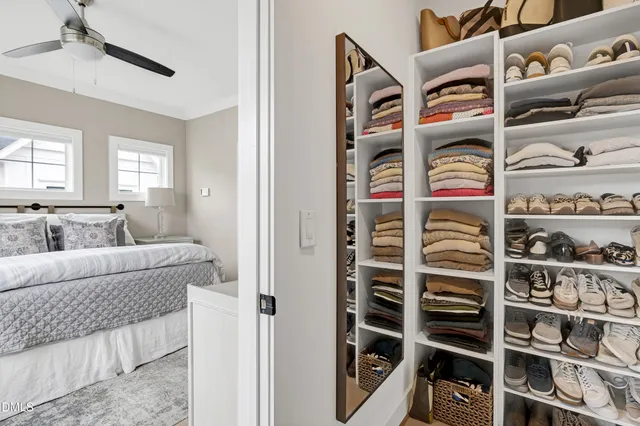 a view of walk in closet with clothes and shoes