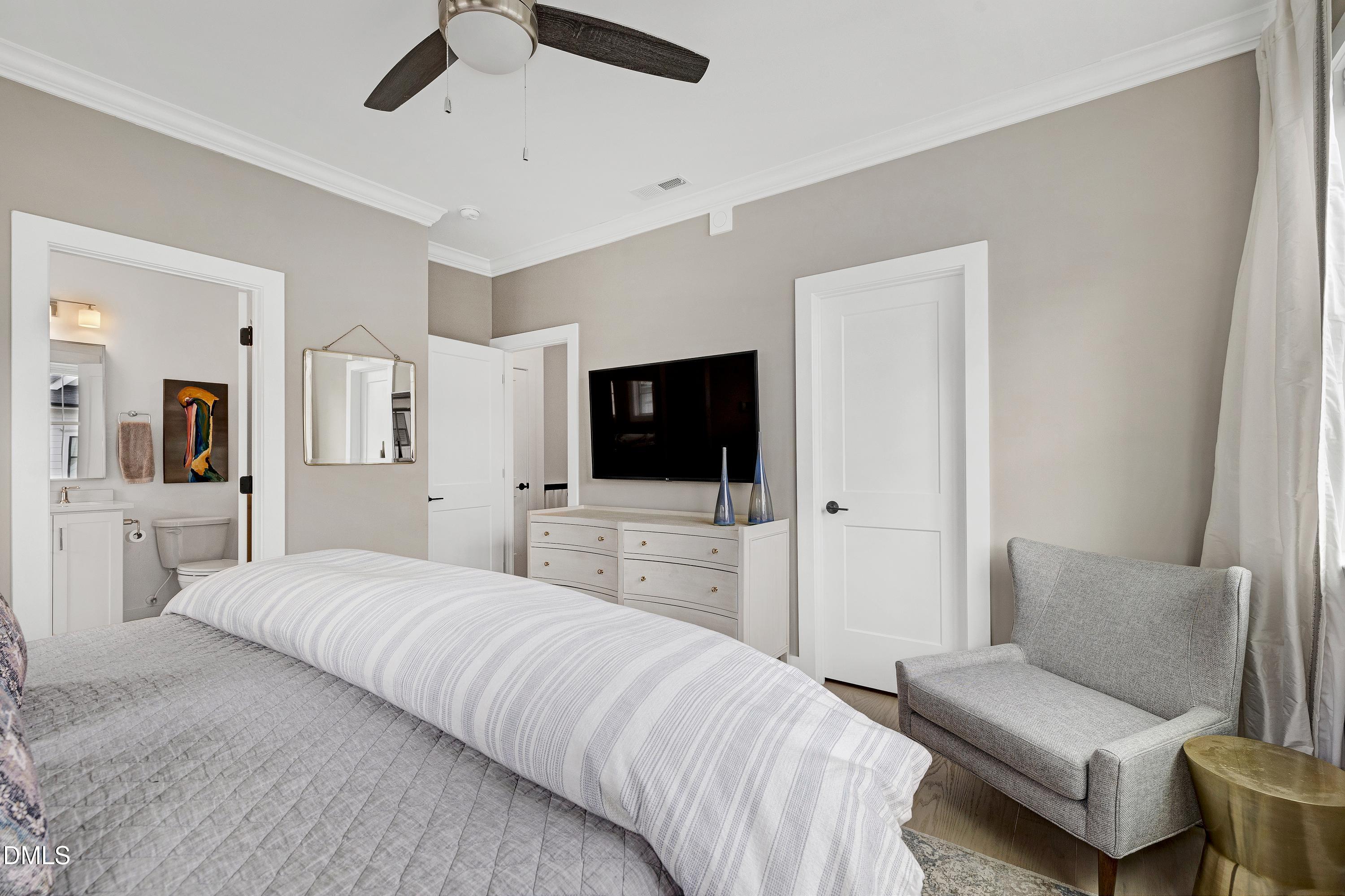 400 Bryan Pointe Drive, Unit 104 Raleigh, NC 27608 - Photo 36 of 66 a bedroom with a bed and a flat screen tv