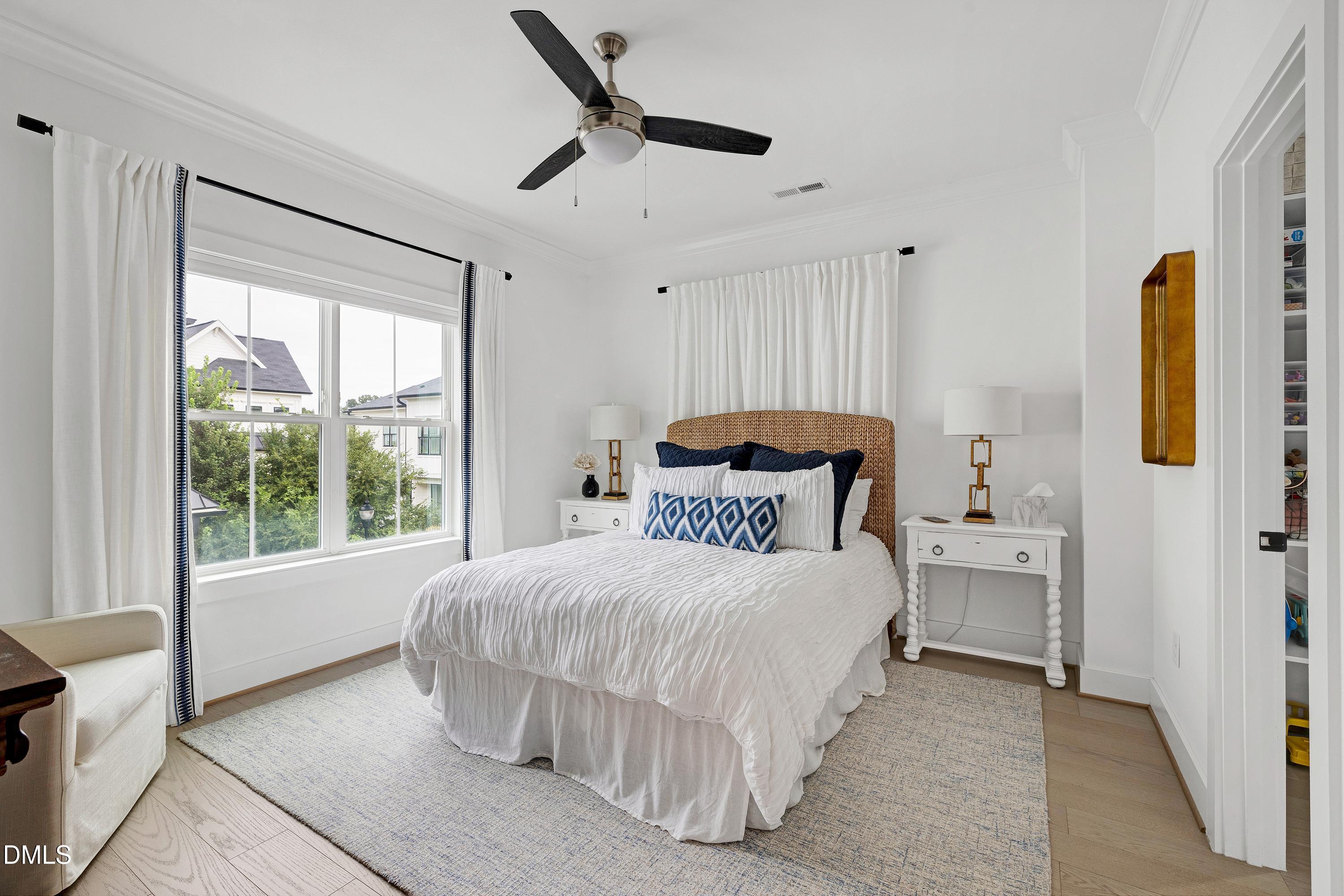 400 Bryan Pointe Drive, Unit 104 Raleigh, NC 27608 - Photo 40 of 66 a bedroom with a bed and a window