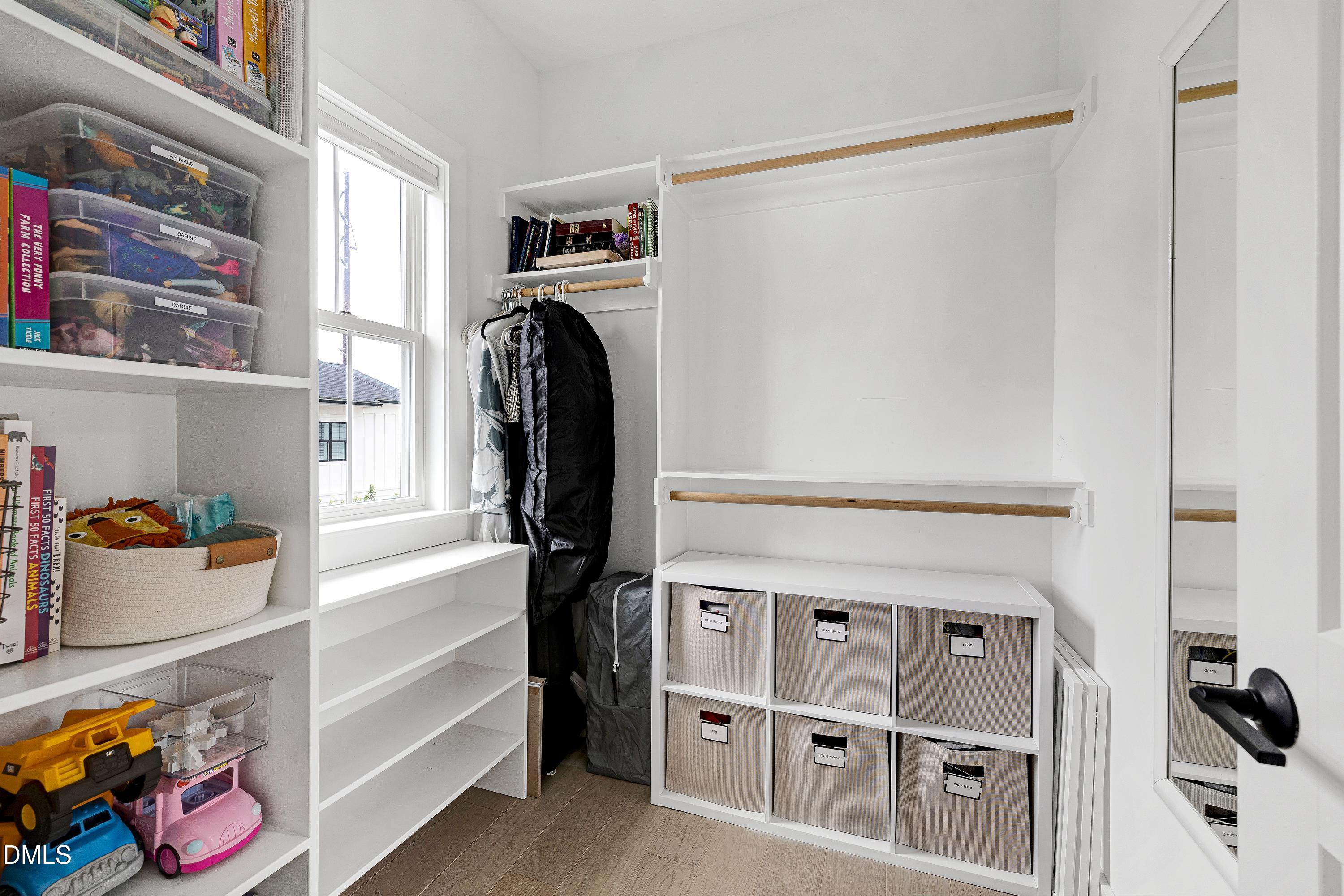 400 Bryan Pointe Drive, Unit 104 Raleigh, NC 27608 - Photo 41 of 66 a view of walk in closet with clothes and shoes