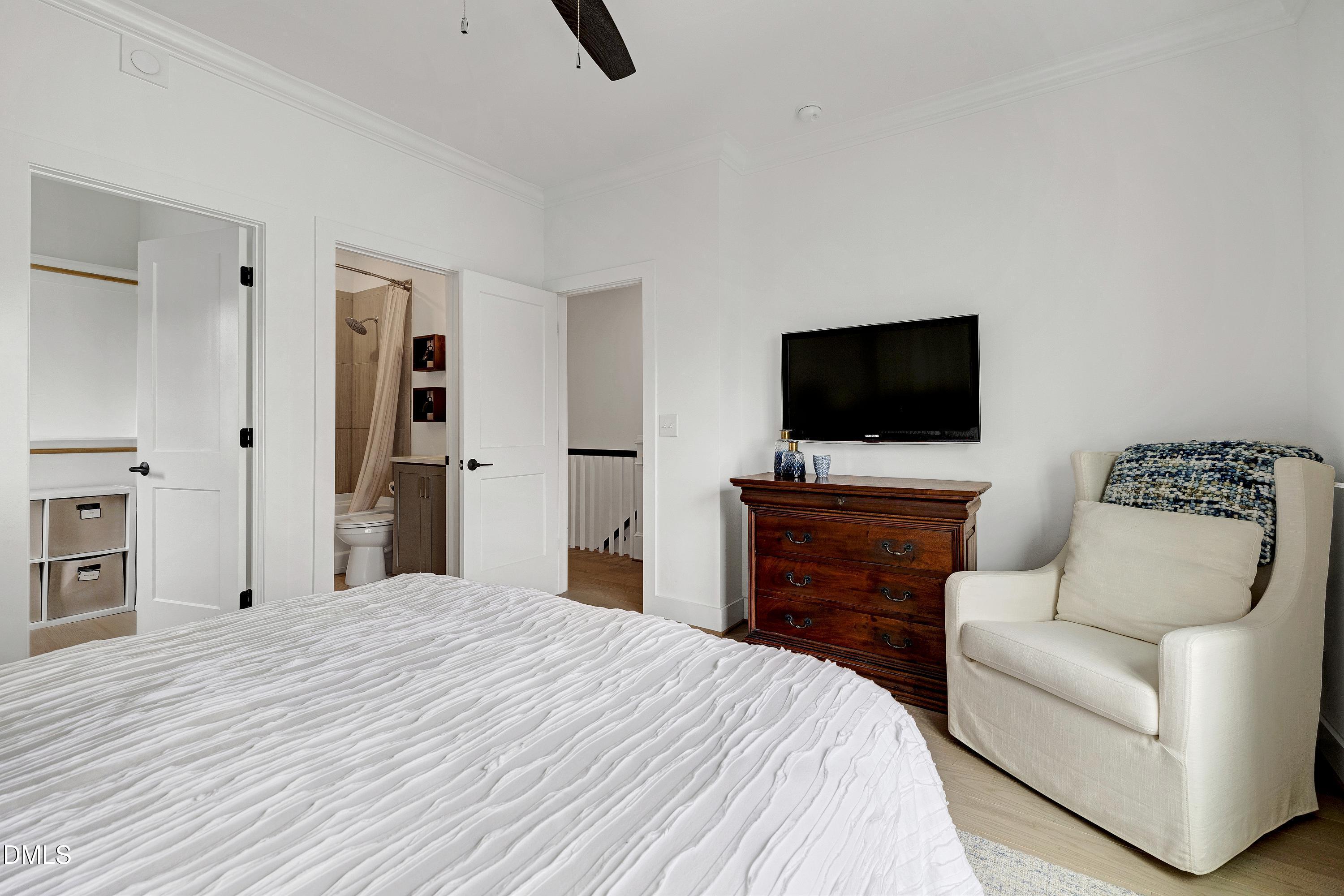 400 Bryan Pointe Drive, Unit 104 Raleigh, NC 27608 - Photo 42 of 66 a bedroom with a bed and a flat screen tv