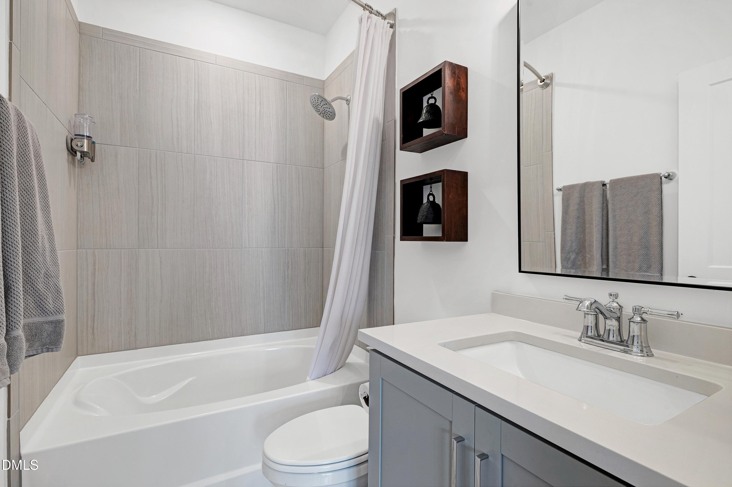 400 Bryan Pointe Drive, Unit 104 Raleigh, NC 27608 - Photo 43 of 66 a bathroom with a granite countertop sink toilet and shower