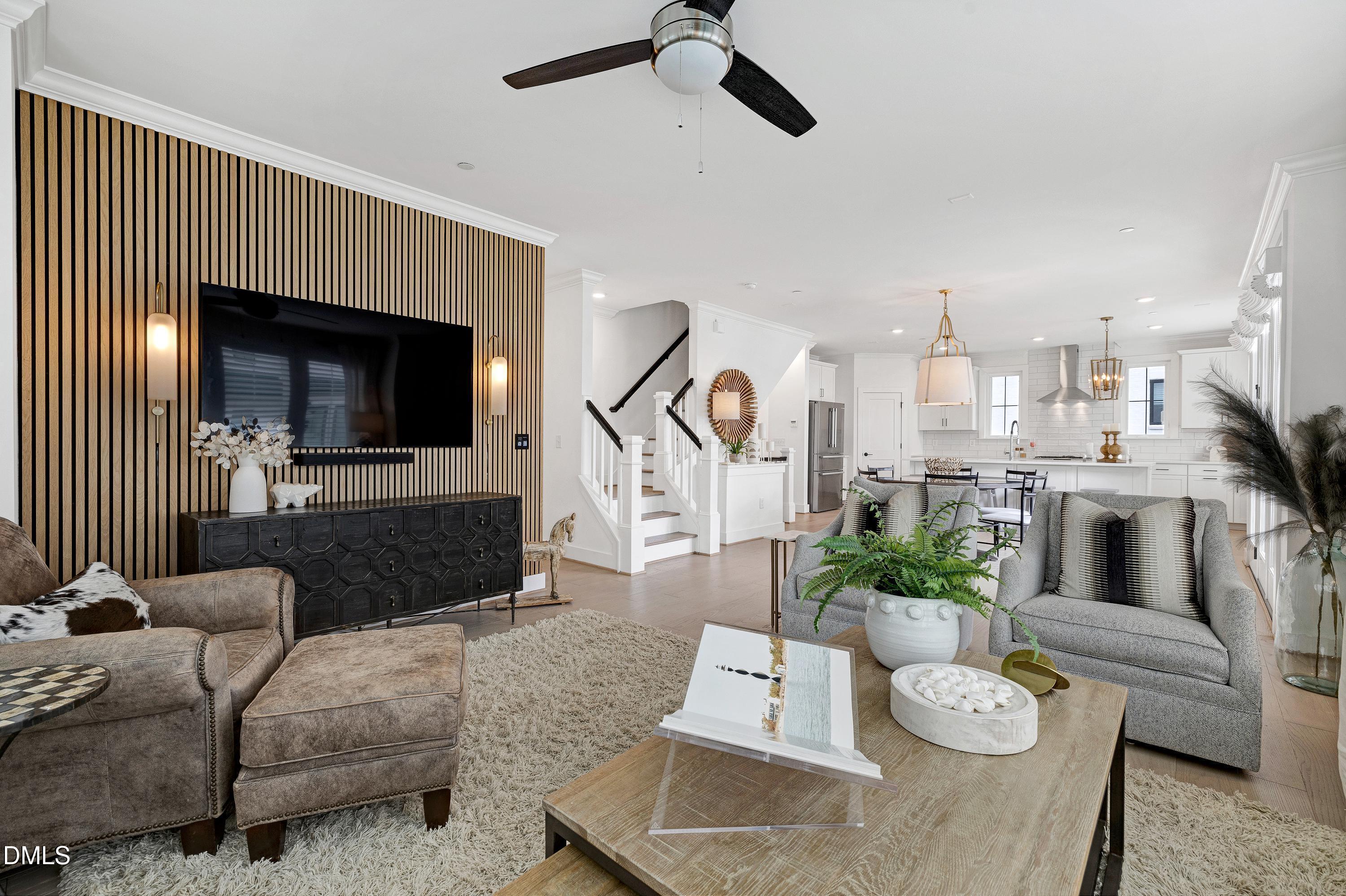400 Bryan Pointe Drive, Unit 104 Raleigh, NC 27608 - Photo 3 of 66 a living room with furniture and a flat screen tv