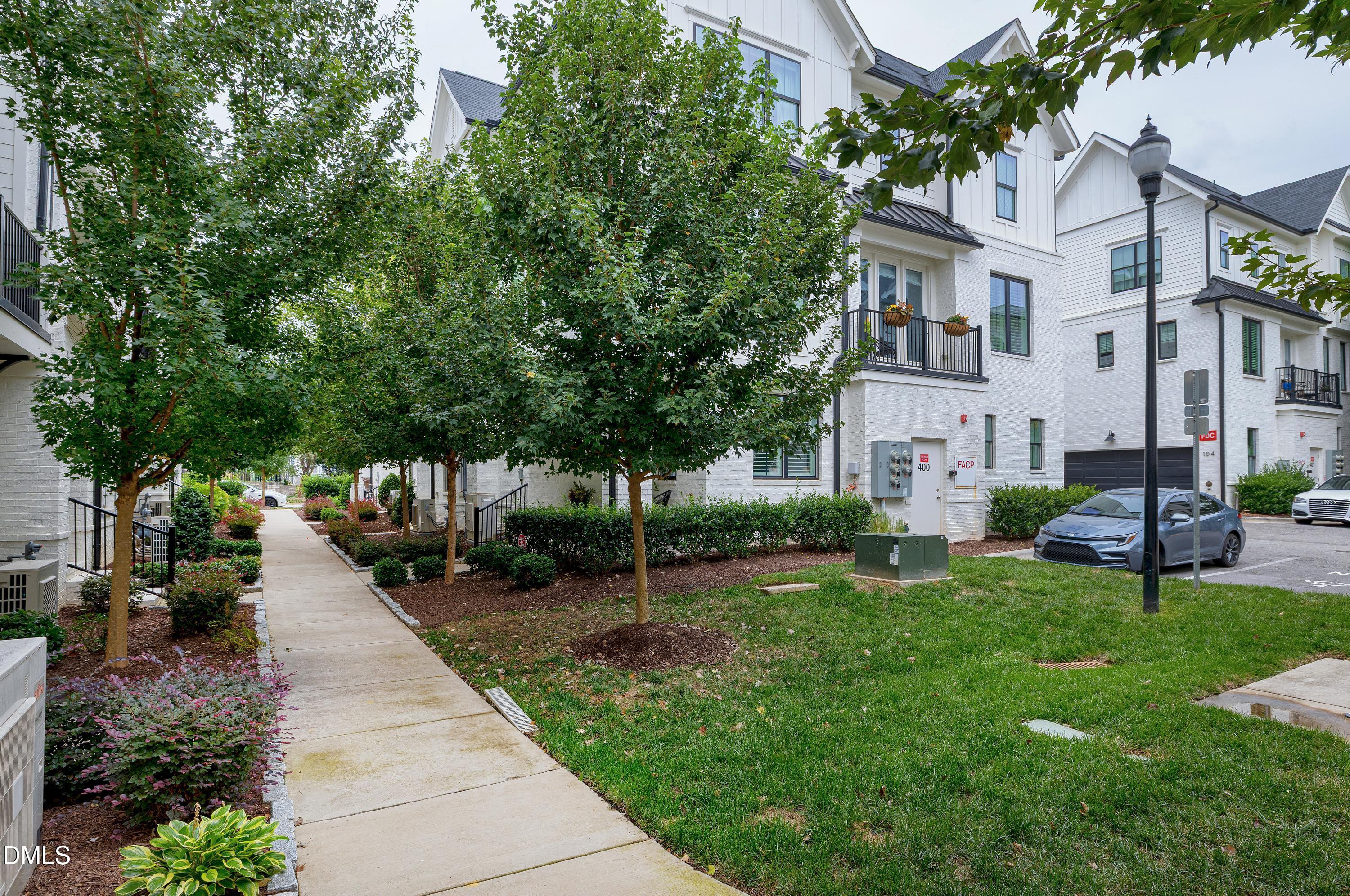 400 Bryan Pointe Drive, Unit 104 Raleigh, NC 27608 - Photo 53 of 66 a view of a park with plants and large trees