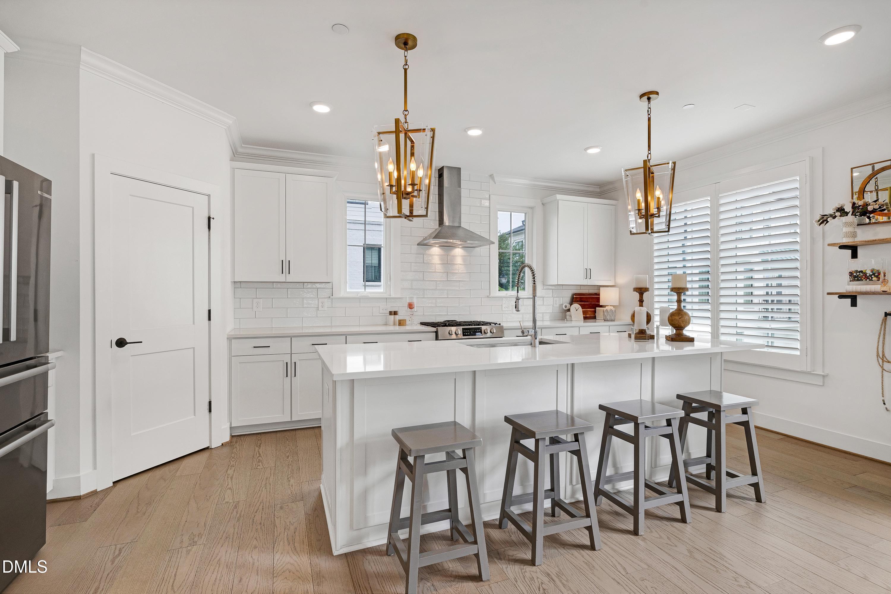 400 Bryan Pointe Drive, Unit 104 Raleigh, NC 27608 - Photo 4 of 66 a large kitchen with a table and chairs in it