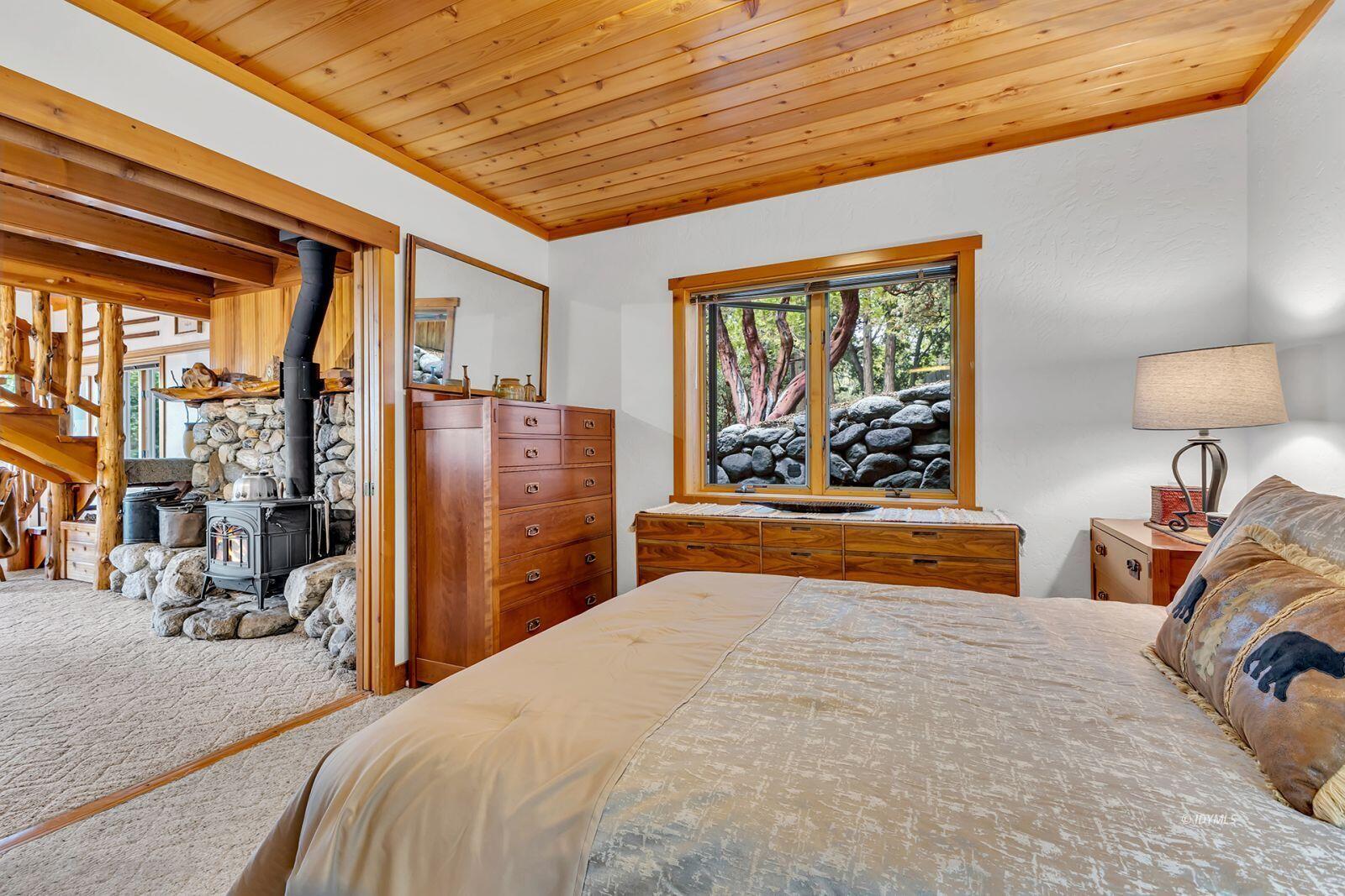 52980 Overlook Drive Idyllwild, CA 92549 - Photo 23 of 60 a bedroom with bed and glass windows