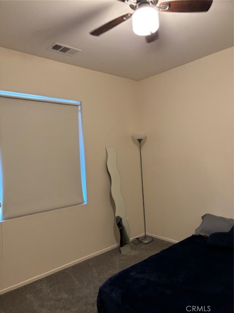 2090 Trinket Circle San Jacinto, CA 92582 - Photo 13 of 22 a bedroom with a bed and a chandelier