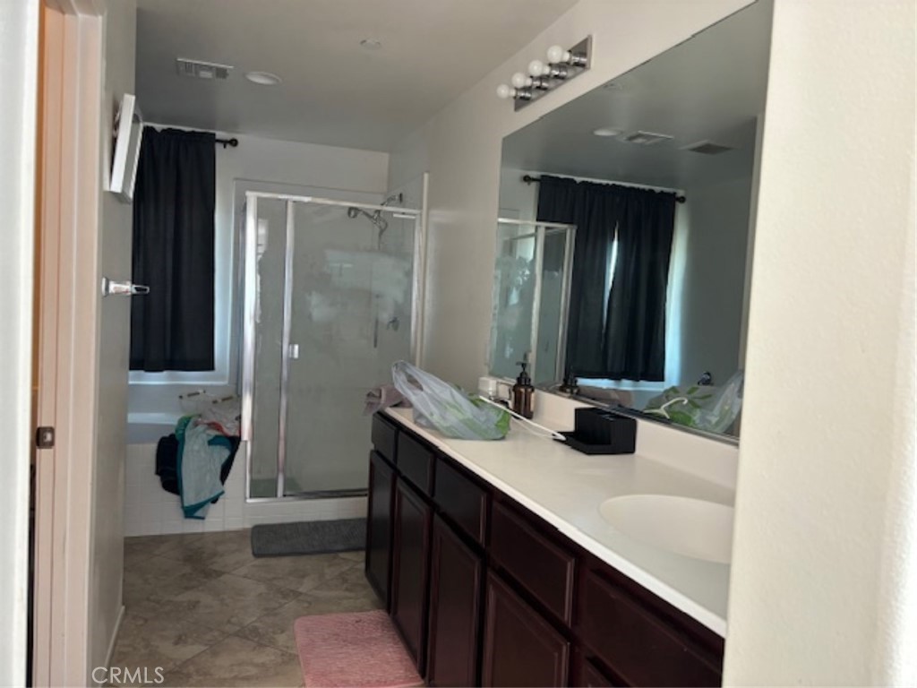 2090 Trinket Circle San Jacinto, CA 92582 - Photo 18 of 22 a bathroom with a sink and a mirror