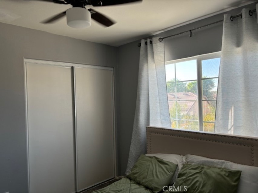 2090 Trinket Circle San Jacinto, CA 92582 - Photo 22 of 22 a living room with a bed and a window