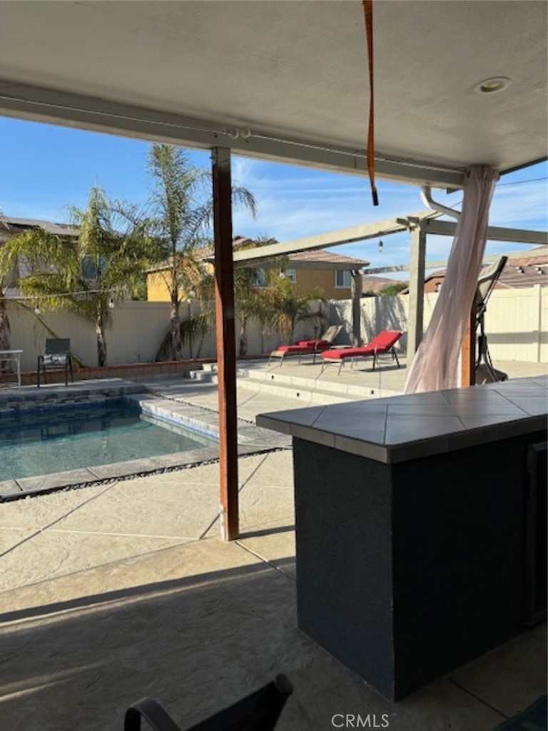 2090 Trinket Circle San Jacinto, CA 92582 - Photo 7 of 22 a view of a room with furniture and a floor to ceiling window
