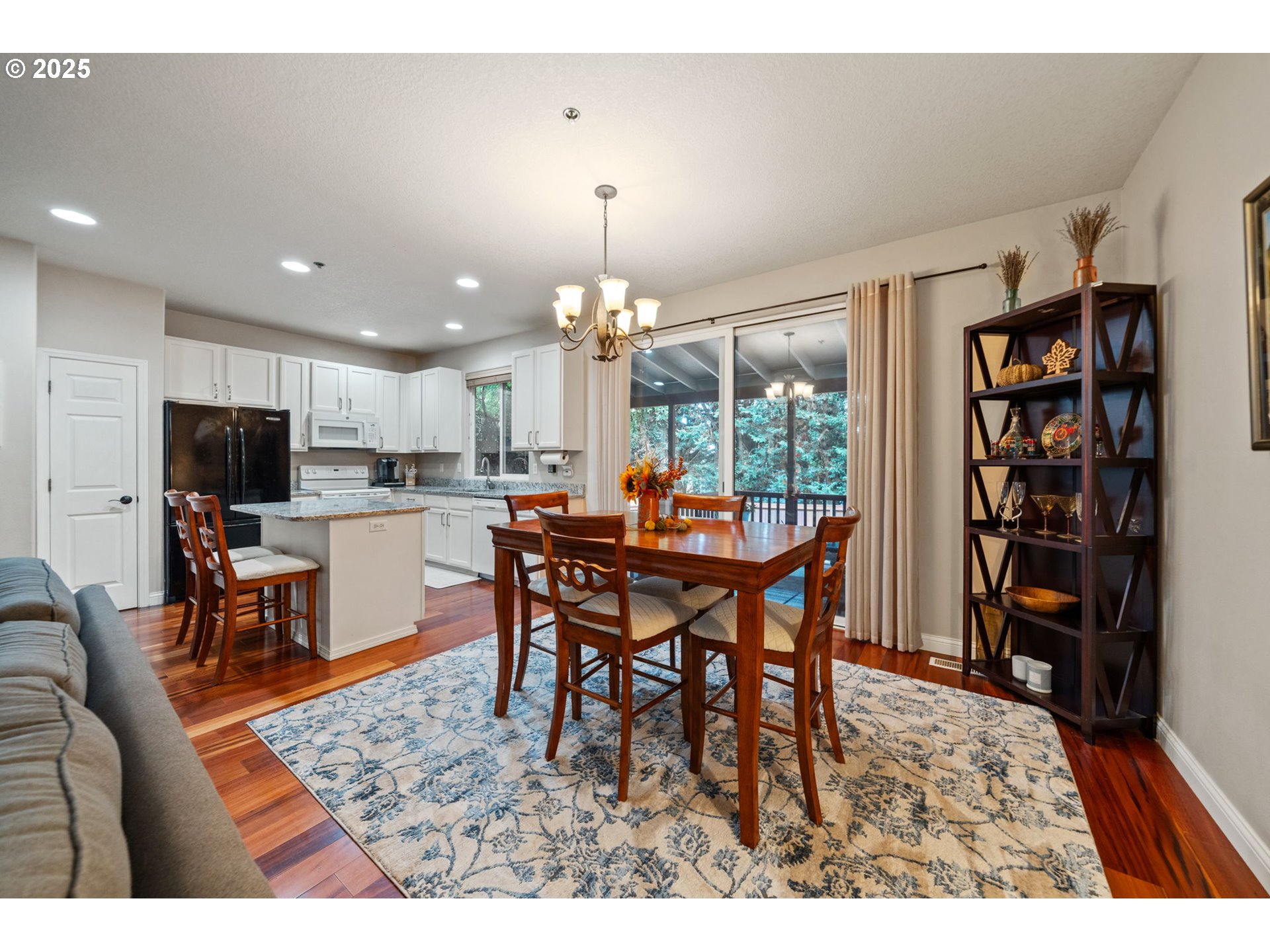 3367 Northwest 31st Circle Camas, WA 98607 - Photo 15 of 30 a dining room with furniture a chandelier and a flat screen tv