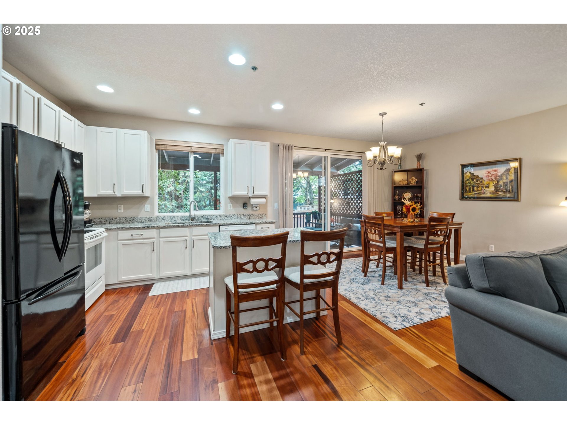 3367 Northwest 31st Circle Camas, WA 98607 - Photo 9 of 30 a living room with stainless steel appliances kitchen island granite countertop furniture wooden floor and a kitchen view