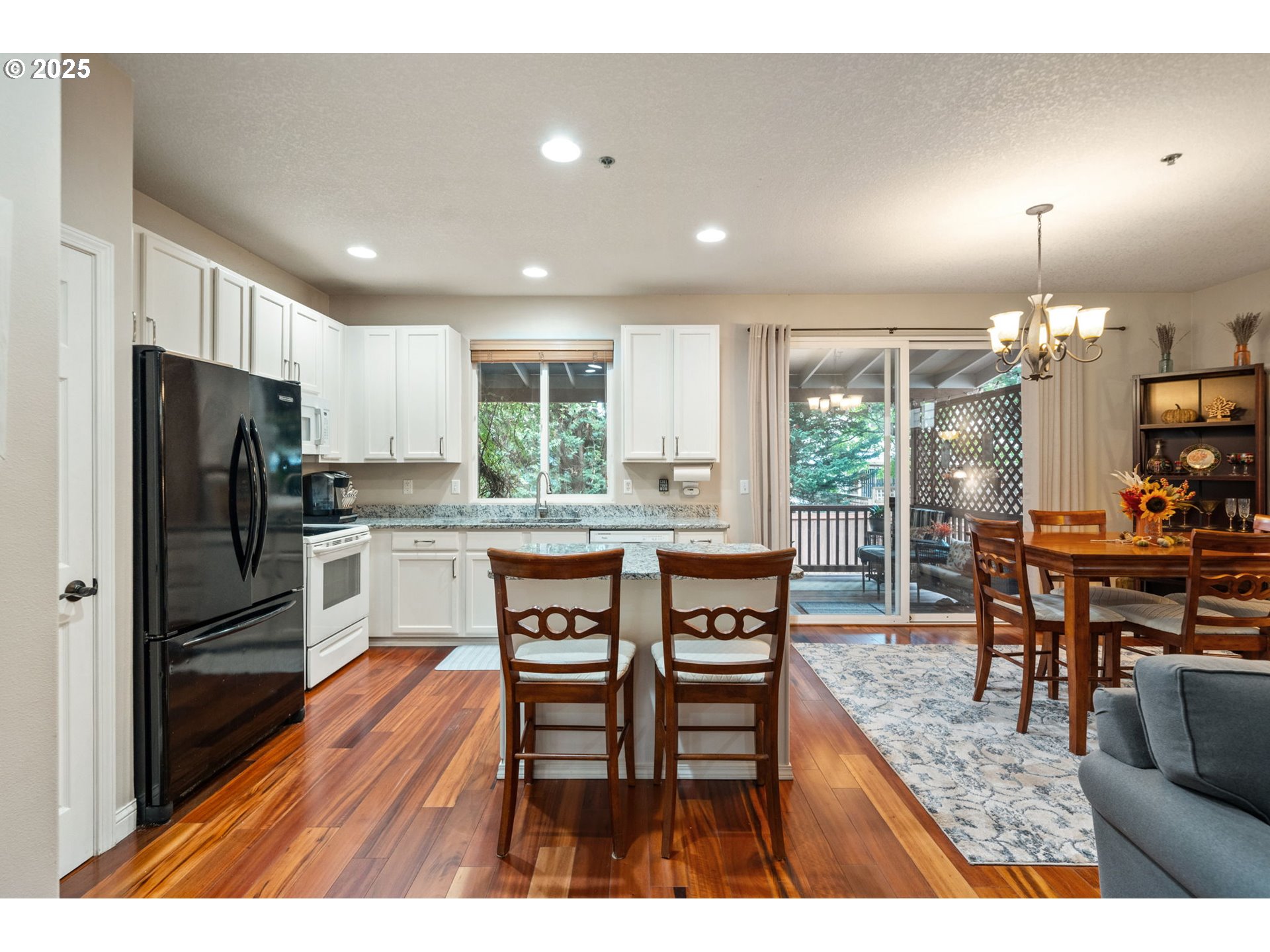 3367 Northwest 31st Circle Camas, WA 98607 - Photo 10 of 30 a kitchen with stainless steel appliances a dining table chairs refrigerator and cabinets