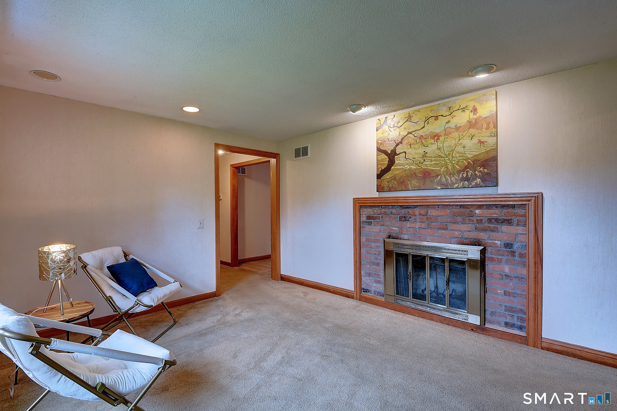 80 Grist Mill Road Wethersfield, CT 06109 - Photo 15 of 40 a living room with furniture a fireplace and a flat screen tv