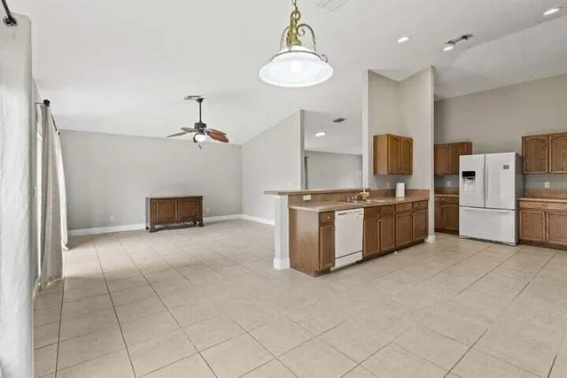 a large kitchen with cabinets and stainless steel appliances