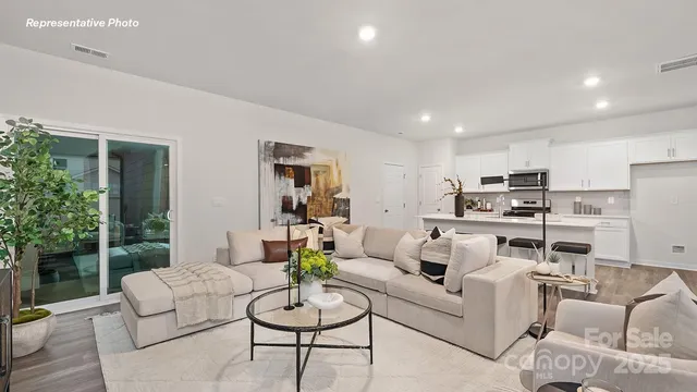 a living room with furniture kitchen and a table