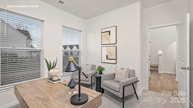 a living room with furniture a rug and a window