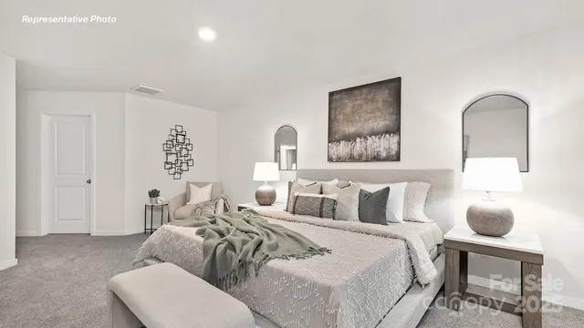 a bedroom with bed and a painting on the wall