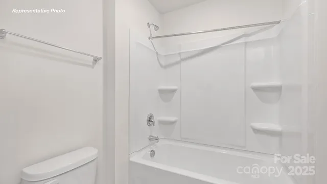 a bathroom with a shower and a toilet